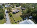 An aerial view of a home showing the ample yard space and perimeter fencing at 16 General Doolittle Rd, Daytona Beach, FL 32124