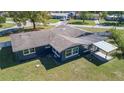 An aerial view showcasing the home's rear exterior and covered patio at 16 General Doolittle Rd, Daytona Beach, FL 32124