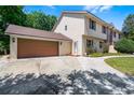 Side view of home featuring a large two-car garage and well-manicured lawn at 16017 Harbar Oaks Dr, Montverde, FL 34756