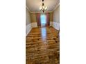 Dining room with crown molding, beautiful hardwood floors, chandelier, and natural light at 16017 Harbor Oaks Dr, Montverde, FL 34756