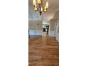 Open-concept living space with hardwood floors that transitions into the adjacent kitchen at 16017 Harbor Oaks Dr, Montverde, FL 34756