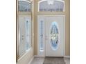 Elegant front door with decorative glass and sidelights, welcoming entrance at 20740 Queen Alexandra Dr, Leesburg, FL 34748