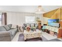 Comfortable living room showcasing cozy gray sofas, pendant lighting, and a view of the room's layout at 212 Taft Dr, Davenport, FL 33837