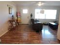 Inviting living room featuring hardwood floors, a ceiling fan, and natural light streaming in through the windows at 2416 Briarwood Ln, Eustis, FL 32726