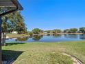 Relaxing backyard featuring a serene water view and lush green lawn at 26636 Evert St, Leesburg, FL 34748