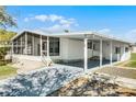 Charming single-story home featuring a carport, screened-in porch, and well-maintained landscaping at 27 Florence Blvd, Debary, FL 32713