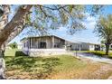 Charming single-story home featuring a carport, screened-in porch, and well-maintained landscaping at 27 Florence Blvd, Debary, FL 32713
