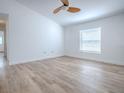 Bright bedroom with wood-look flooring, a ceiling fan, and a large window at 2741 S Brown Ave, Orlando, FL 32806
