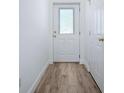 Bright hallway features wood-look floors, neutral walls, and white doors and trim at 2741 S Brown Ave, Orlando, FL 32806