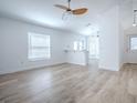 Open-concept living room with wood-look flooring, neutral walls, and lots of natural light at 2741 S Brown Ave, Orlando, FL 32806
