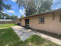Wide backyard with a concrete patio and sliding glass door that provides seamless indoor-outdoor living at 3309 Ne 16Th Ave, Ocala, FL 34479