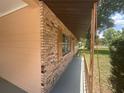 Inviting front porch with brick accents and wood railing, perfect for enjoying the neighborhood views at 3309 Ne 16Th Ave, Ocala, FL 34479