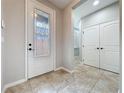 Bright entryway featuring tile flooring and a decorative glass front door at 345 Alcove Dr, Groveland, FL 34736