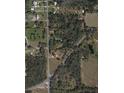 Expansive aerial view of a wooded property with ponds and roadways, offering privacy and natural surroundings at 36126 Cr 439, Eustis, FL 32726