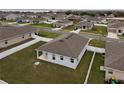 An elevated back view shows a charming home with a backyard and views of a tranquil lake at 37031 Lake Overlook Dr, Grand Island, FL 32735