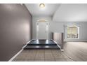 View of the home entryway with tile flooring, half-wall and light colored walls at 3900 Sw 102Nd Pl, Ocala, FL 34476