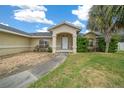 Inviting home entrance with covered porch, manicured shrubs, and a pathway leading to the front door at 3900 Sw 102Nd Pl, Ocala, FL 34476