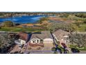 Aerial view of single Gathering home with lush landscaping, a large body of water, and a defined blue lot line at 4818 Sawgrass Lake Cir, Leesburg, FL 34748