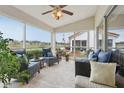 Enclosed sunroom features comfortable seating and serene views of the surrounding landscape, perfect for relaxation at 5056 Harbour Dr, Oxford, FL 34484
