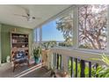 Bright sun room with views of the open water, large windows, and a ceiling fan at 601 N Mcdonald St # 208, Mount Dora, FL 32757