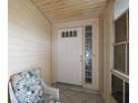 Inviting front porch with tiled floor, decorative glass, and comfortable seating at 6022 Wilander St, Leesburg, FL 34748