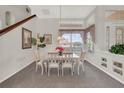 Dining room featuring large windows, neutral carpet, and elegant chandelier at 6122 Sailboat Ave, Tavares, FL 32778