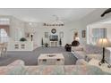 Spacious living room featuring a ceiling fan and a comfortable seating area at 6122 Sailboat Ave, Tavares, FL 32778
