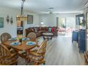 A comfortably furnished living room includes a dining area, a large sectional, and sliding glass doors at 773 Artesia Ave, The Villages, FL 32162