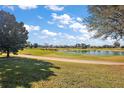 Scenic view of lush golf course with serene lake and expansive green landscape at 776 Alcott Ave, The Villages, FL 32162