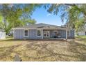 A spacious backyard with a covered patio area, perfect for outdoor entertaining and relaxation at 804 Deep Wood Ct, Fruitland Park, FL 34731