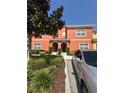 Charming two-story home with mature landscaping and a silver car parked in front at 8973 Cat Palm Rd, Kissimmee, FL 34747