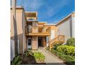 Charming condo with a private balcony and lush landscaping, creating a welcoming entrance at 1051 S Highland St # 7E, Mount Dora, FL 32757