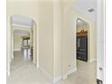 Inviting foyer showcasing arched doorways, neutral paint, and sleek tile flooring throughout at 10929 Se 167Th Pl, Summerfield, FL 34491