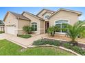 Inviting home exterior with lush landscaping, manicured lawn, and a welcoming front entrance at 10929 Se 167Th Pl, Summerfield, FL 34491
