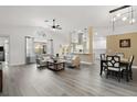 Spacious open-concept living area with modern flooring, vaulted ceilings, and seamlessly connected kitchen and dining spaces at 11684 Sw 72Nd Cir, Ocala, FL 34476