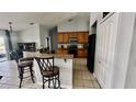 Well-equipped kitchen featuring wooden cabinets, granite countertops, and modern appliances at 11727 Pineloch Loop, Clermont, FL 34711