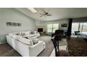 Spacious living room featuring a vaulted ceiling, cozy fireplace, and comfortable seating at 11727 Pineloch Loop, Clermont, FL 34711