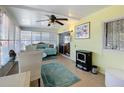 Bright and airy sunroom featuring large windows, a ceiling fan, comfortable seating, and a tranquil space to relax at 1340 Elkhart Cir, Tavares, FL 32778