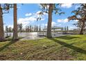 Picturesque backyard with a covered dock overlooking the serene lake and lush greenery at 1401 W Highway 50 # 173, Clermont, FL 34711