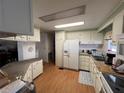 Functional kitchen with white cabinets, modern appliances, and ample counter space at 146 Jacaranda Dr, Leesburg, FL 34748