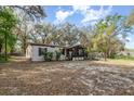 Quaint home featuring light siding, black shutters, screened porch and wheelchair ramp at 1638 Leesburg Blvd, Fruitland Park, FL 34731
