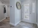Elegant entryway features a decorative door, stylish flooring, and a unique wall decoration at 17714 Se 84Th Sheldon Ter, The Villages, FL 32162