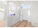 Bright foyer with tile flooring, decorative columns, and arched window above the front door at 20755 Queen Alexandra Dr, Leesburg, FL 34748