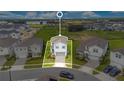 Aerial view of a neatly bordered home with landscaped yard in a suburban neighborhood at 2116 Lelani Cir, Davenport, FL 33897