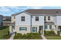 Attractive townhouse featuring well-kept landscaping, neutral color palette, and a welcoming facade at 213 Primrose Dr, Davenport, FL 33837