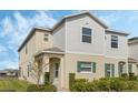 Charming two-story townhouse with a landscaped yard, neutral siding, and welcoming entrance at 213 Primrose Dr, Davenport, FL 33837