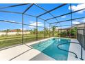 Enjoy this gorgeous screened-in pool and backyard with lush landscaping, perfect for relaxing or entertaining at 2174 Wallingford Loop, Mount Dora, FL 32757