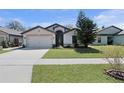 This charming single-Gathering home features a well-manicured lawn and two car garage at 2376 Bexley Dr, Tavares, FL 32778