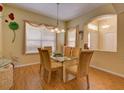 Bright dining room features a glass table with six chairs and natural light from the windows at 24104 Robinwood St, Leesburg, FL 34748