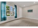 Bright bedroom featuring plush carpeting, a window with sheer curtains, and neutral wall paint at 3054 Hill Point St, Minneola, FL 34715